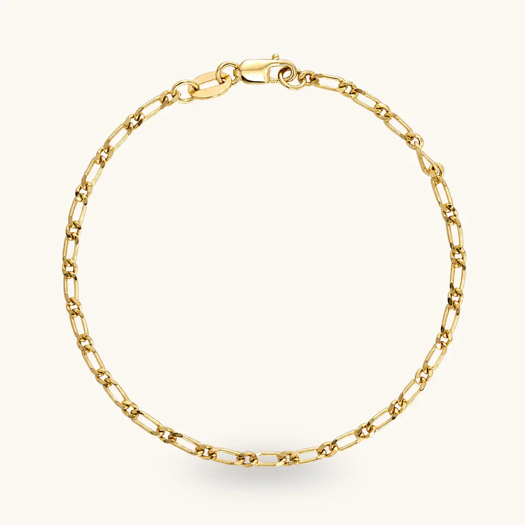 A gold chain bracelet with a classic paperclip link design and a lobster clasp, displayed on a clean off-white background.