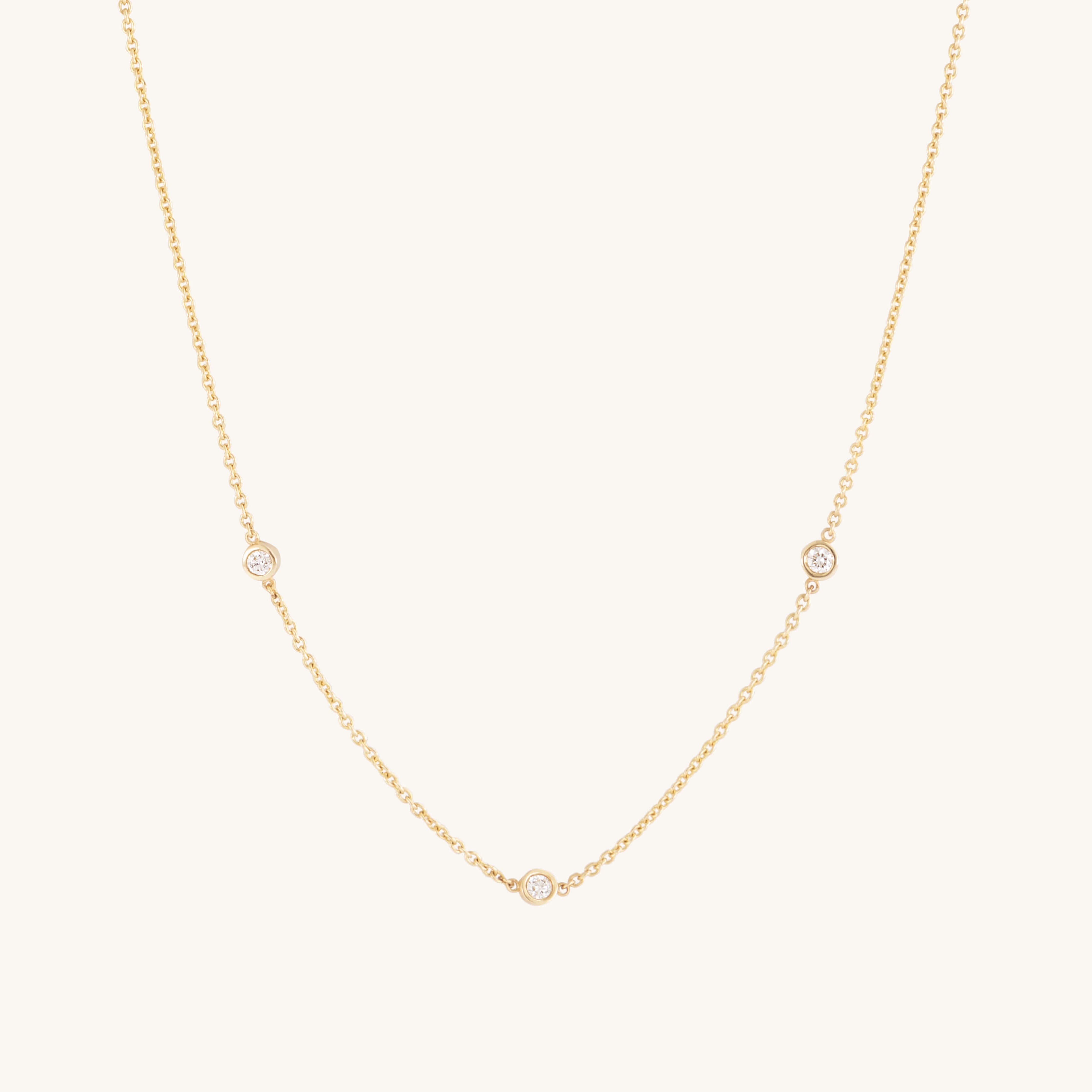 The Glasâje Satellite Necklace features 9ct solid gold with three small ethically-grown diamonds spaced along the lower chain, shown on a plain light background.
