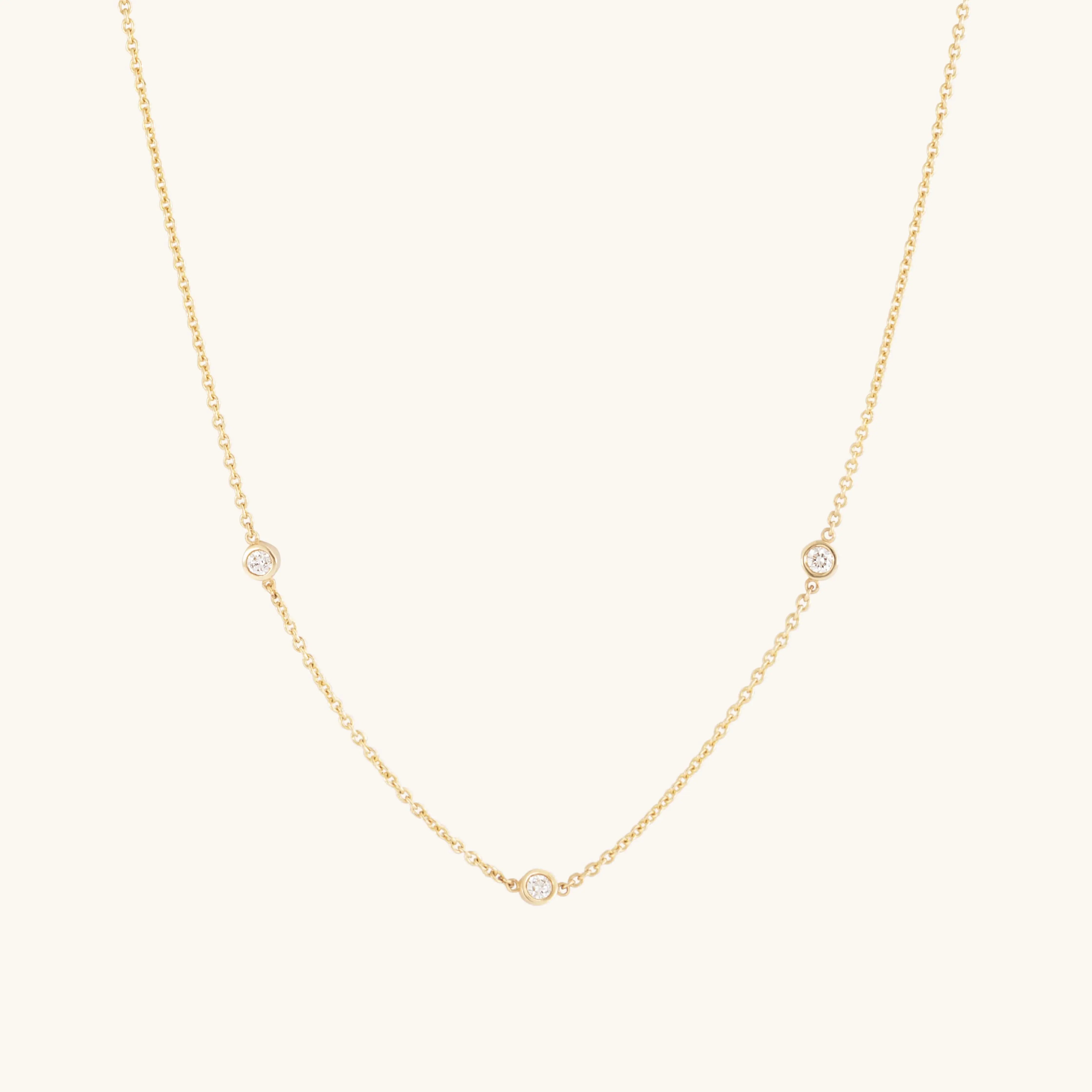 The Glasâje Satellite Necklace features 9ct solid gold with three small ethically-grown diamonds spaced along the lower chain, shown on a plain light background.