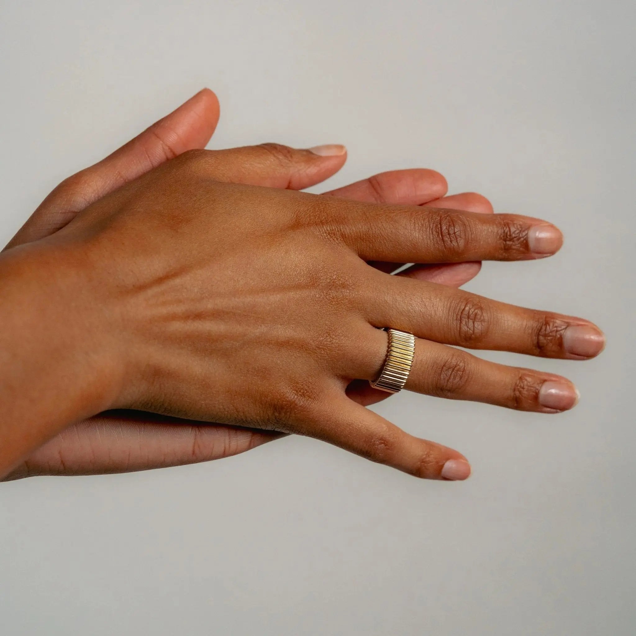 Model wearing Baxter Ring in 9ct solid gold stacked with stacking bands
