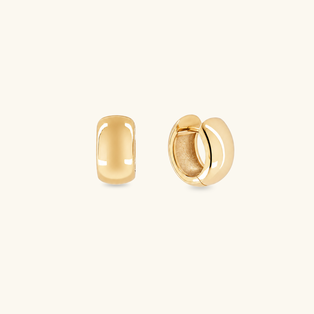 A pair of polished gold huggie hoop earrings shown from two angles on a clean, off-white background.