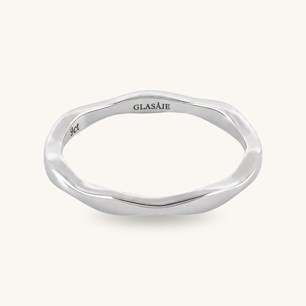A polished silver ring with an organic, wavy, fluid outline shape, featuring the brand name 'GLASAJE' and '925' sterling silver mark engraved on the inside, set against a solid off-white background.